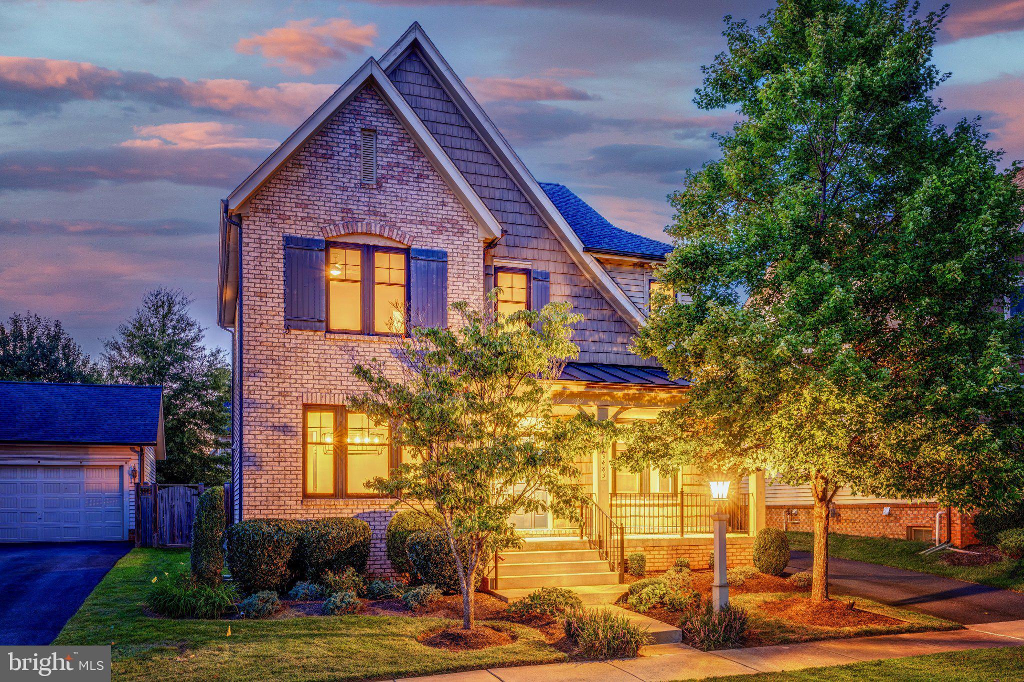 From the moment you pull up the long driveway, past the manicured front yard and that contemporary brick facade, you can feel this home was cared for. Built by Miller & Smith as part of their English Manor inspired Noble Pointe Collection, it sits in the heart of Brambleton, one of Ashburn's most sought after communities, where five neighborhood pools (two of them within half a mile), miles of walking trails, and Morning Walk Park with its zip lines and playgrounds are just the beginning. Step through the front door and the nine foot ceilings set the tone immediately, opening into a kitchen made for real life, a huge island with seating, espresso cabinetry, quartz counters, stainless appliances, a gas cooktop, wall oven and built in microwave, with a breakfast nook for easy mornings and an open flow into the family room where a gas fireplace and walls of windows make every gathering feel warm and bright. A door off the family room opens right onto the paver patio, where grilling and eating outside come easy, with a view over the fenced, well kept backyard. The main level also offers a formal dining room connected to the kitchen through a butler's pantry, a private office with modern navy built ins and french doors for when work from home needs to feel like its own space, and a convenient powder room. Upstairs, three spacious bedrooms and an open loft give everyone room to spread out, with the primary suite a true retreat, a trey ceiling, an en suite bath with a seamless shower, dual sink vanity and a separate makeup vanity, plus a generous walk in closet, while the secondary bedrooms share a nicely appointed bath and the loft becomes whatever your family needs it to be, a second living room, a playroom, a quiet reading nook. And upstairs laundry means you'll never haul another basket up and down the stairs. The fully finished walkup basement adds even more, a rec room for movie nights or game days, a legal bedroom and full bath for guests, and a flex room ready to be a home gym, hobby space or extra sitting room, with two additional utility rooms offering storage now and expansion potential later. Beyond your front door, Brambleton offers a town center just a mile away with Onelife Fitness, Regal Cinema, restaurants, grocery stores, and the community library, Hanson Regional Park two miles out with a splashpad, sports fields and a dog park, and a lively farmers market and calendar of community events that make this neighborhood feel like home the moment you arrive. The home is zoned for top rated Madison's Trust Elementary, Brambleton Middle, and Independence High School. This home has been thoughtfully maintained too, with a new roof in 2024, a new water heater in 2022, a water softener added in 2025, a new HVAC system in 2022 that's dual zoned with a steam humidifier and air purifier, and a new fridge and dishwasher in 2025, so all you have to do is move in and start making memories.