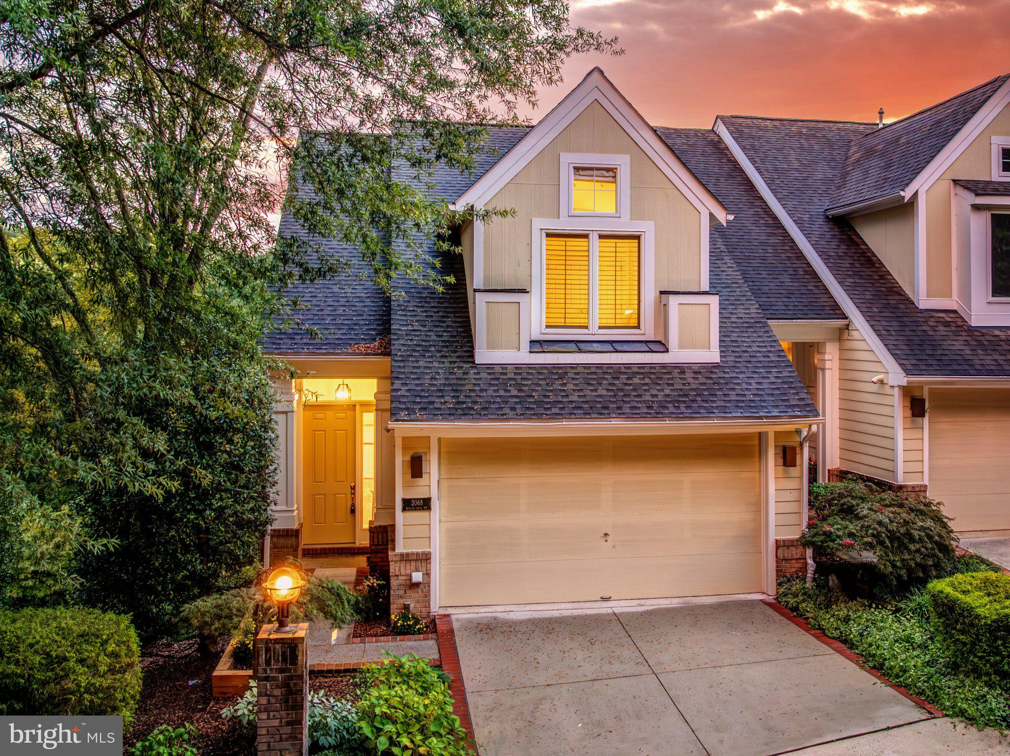 Wake up with Lake Audubon right outside your back door. This five level elevator townhome puts the water front and center, and the moment you walk in, a wall of windows frames winter lake views and a leafy tree line in the summer. Picture a sunrise kayak before the day gets going, an after work paddleboard session, or a quiet cup of coffee on the oversized Trex deck with the awning pulled out when the sun gets warm. Downstairs on the main level, cathedral ceilings and huge picture windows make the family room feel wide open, with a gas fireplace surrounded by built ins and double glass French doors across the entire back wall that pour in even more light and lead straight out to the deck. The formal dining room flows right into a gourmet kitchen with an oversized island, gas cooktop, dual wall ovens, built in microwave, granite counters, and 42 inch off white cabinetry with glass front upper cabinets lit from the inside, all over beautiful hardwood floors. This level also has a huge laundry room with plenty of pantry space and a powder room. The foyer level welcomes you with more hardwood and built ins, and the elevator sits just to the right to carry you up to two generous bedrooms, one an ensuite with a walk in closet and the other paired with a nicely appointed bath. Below the main level, the primary suite is massive, with wide views of the trees out back, two walk in closets with organizers, and a bath with two separate vanities, each with its own storage, plus a large soaking tub and a stand up shower. The lowest level is a blank canvas for movie nights, a home gym, hobbies, or a crowd, with recessed lighting, a full bath with a custom walk in tub, and a walkout to a large brick paver patio that is ready for wine, coffee, or a full backyard party. A perfectly manicured lawn rolls all the way down to the water, and two private community docks put the lake within easy reach. Two HVAC systems keep the home zoned and comfortable, and the two car garage makes daily life easy. You can walk to South Lakes Shopping Center for groceries, dinner, and errands, and the Lake Audubon pool and Reston Wiehle Metro station are close by. The Dulles Toll Road is just minutes away, with Dulles Airport and Tysons each about 8 miles out. Don't miss this chance to own a truly special home on beautiful Lake Audubon. As part of Reston Association, residents enjoy access to 15 pools, 55 miles of trails, numerous parks, 4 beautiful lakes, 52 tennis courts, 18 pickle ball courts, a variety of community events and programs throughout the year including festivals, concerts, workshops, and social gatherings, plus several community centers including the Reston Association headquarters, Walker Nature Center, and the Lake House at Lake Newport, which offer space for meetings, classes, and special events. Roof 2022, Water Heater 2022, HVAC 2017, HVAC 2014.