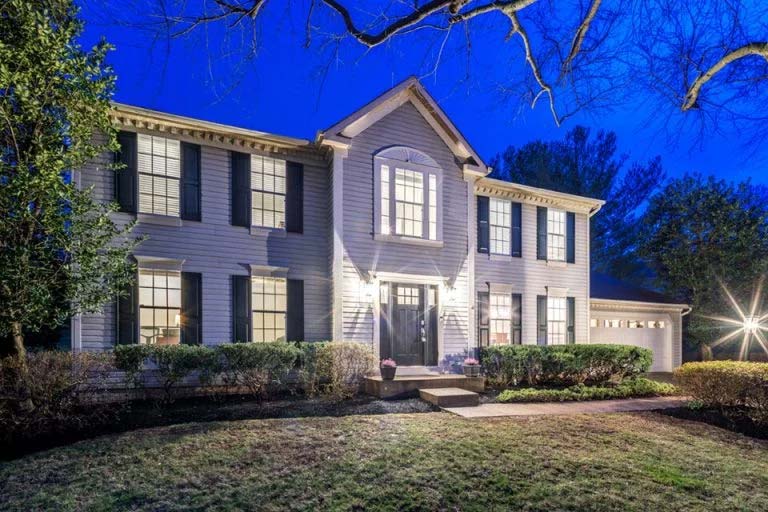 A beautiful two story home pictured during night