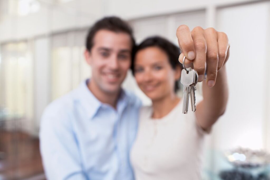 A couple with a set of keys to their new home 