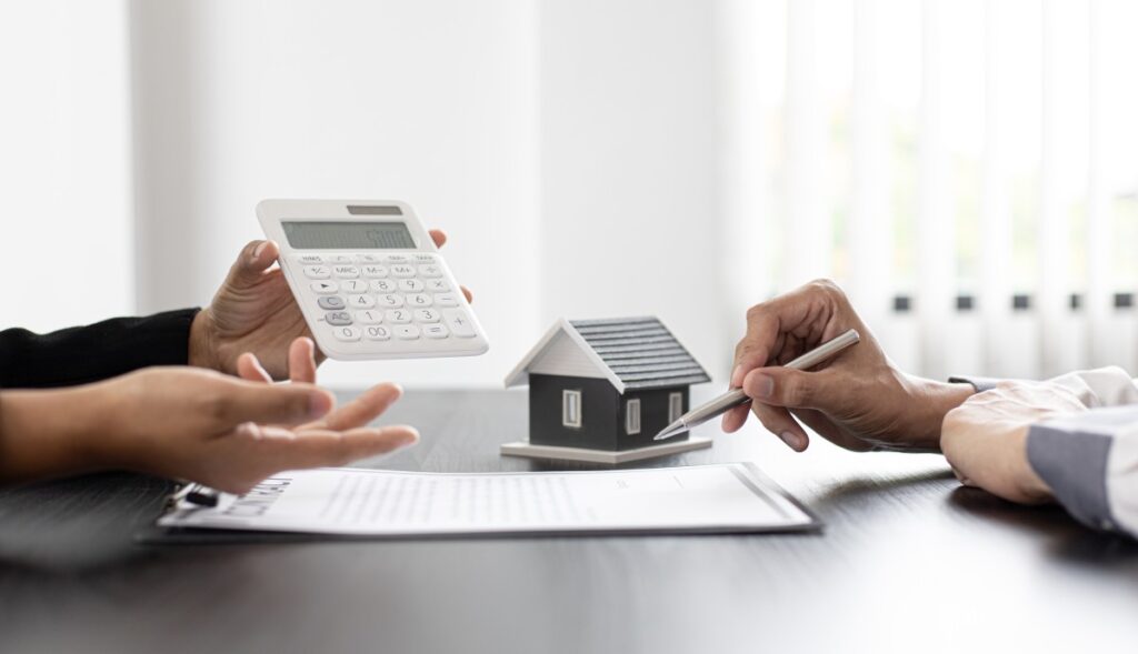 A real estate agent shows a calculation to a client during contract discussions. 