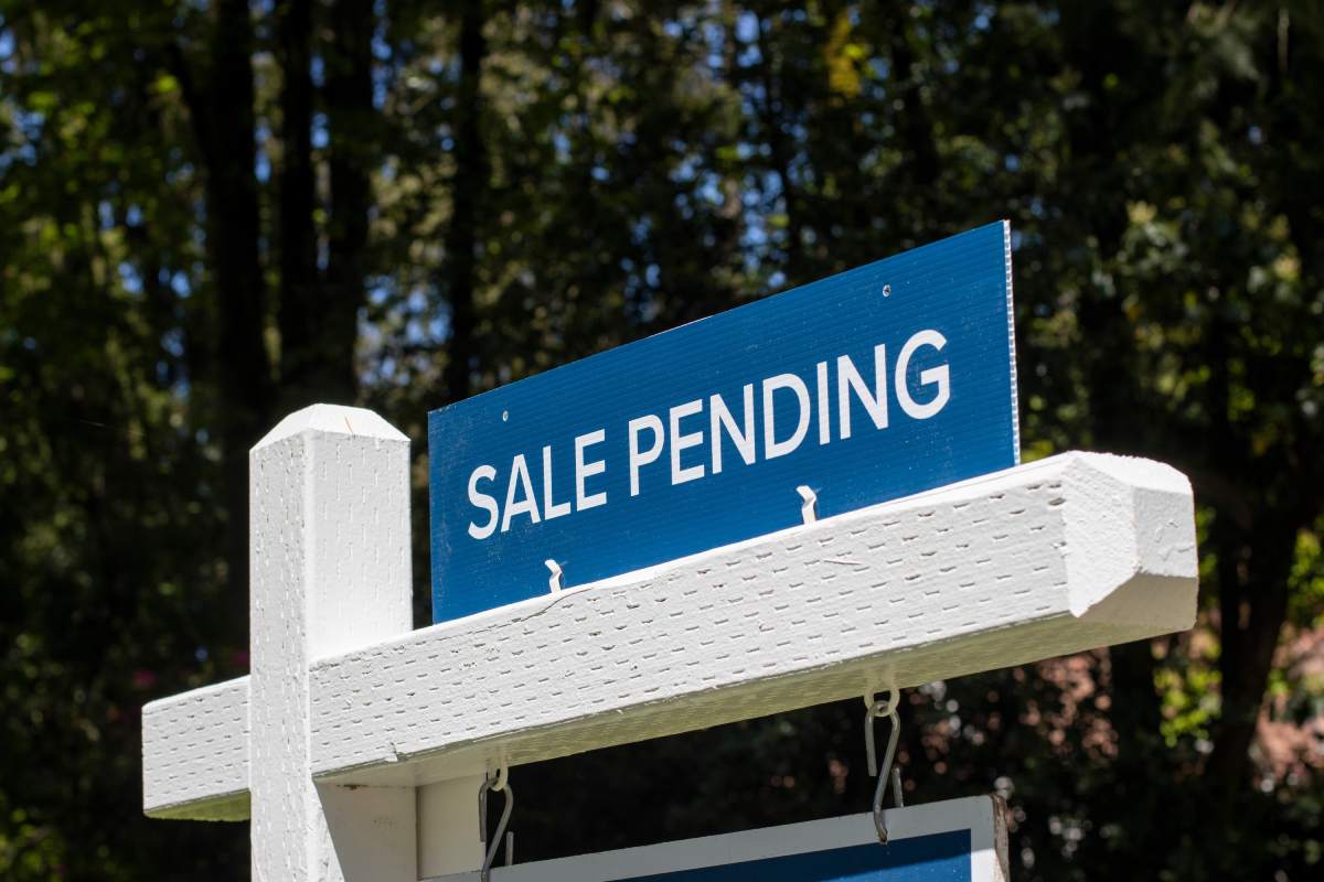A “sale pending” sign seen on top of a real estate “for sale” sign.