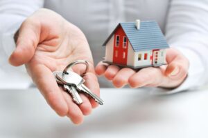 A real estate agent showing a house and keys