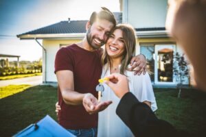 A happy couple receives the keys to their new home.