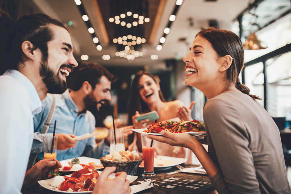 A group of friends enjoy a meal at a restaurant.