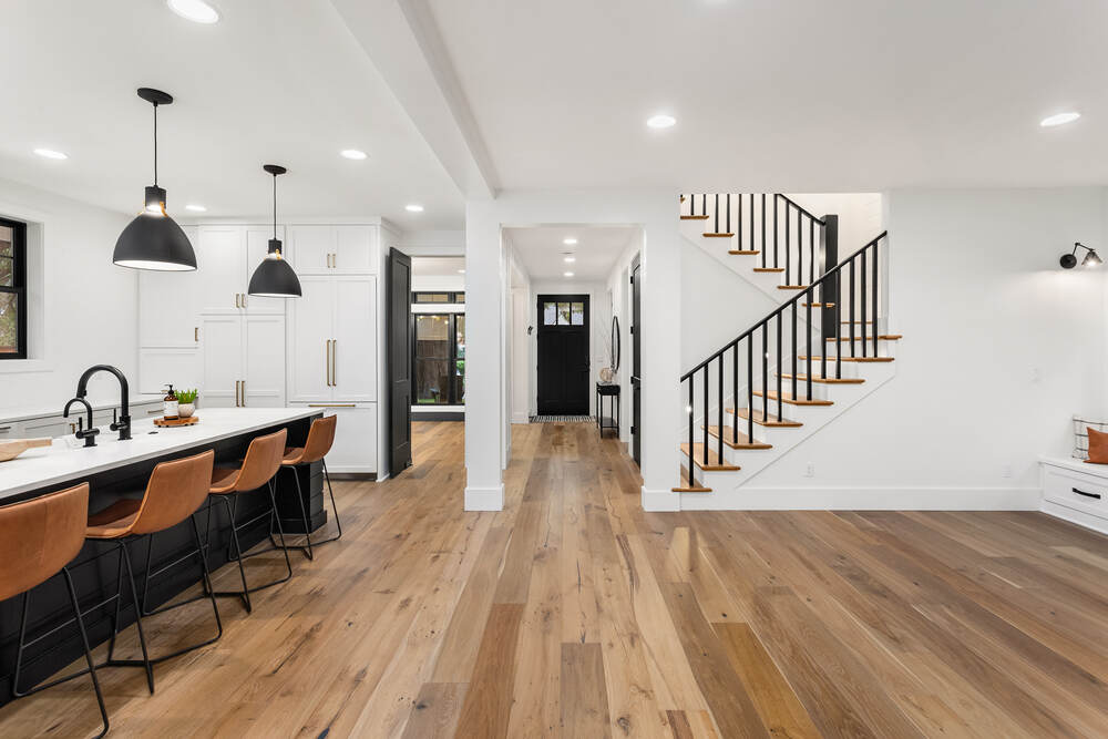 New hardwood floors are visible in a home’s kitchen. 