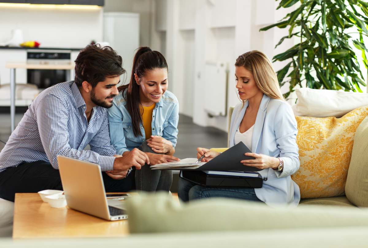 A Realtor reviews a property offer with her clients.