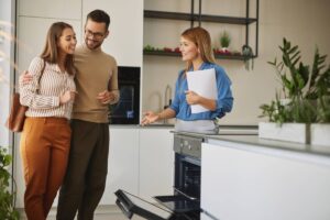 A realtor shows a couple a home