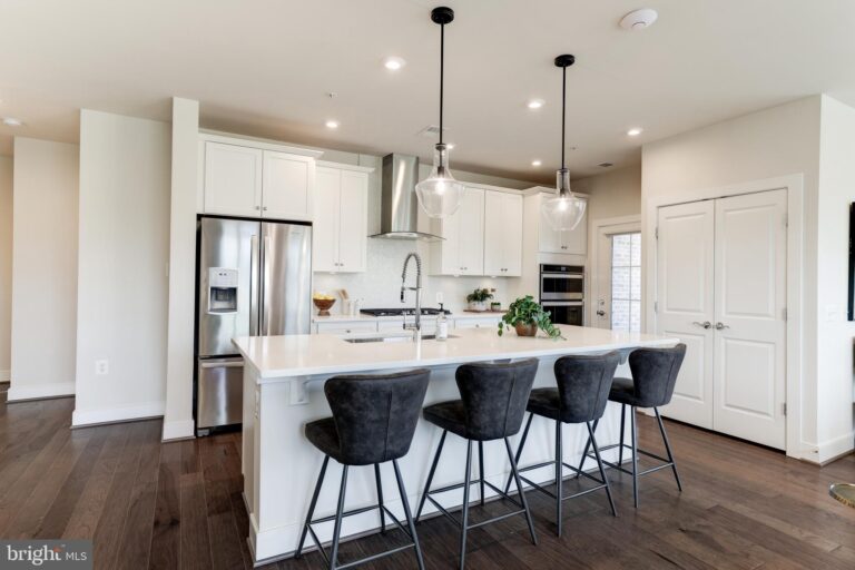 White kitchen with island and black bar stools, 2319 Field Point Road 104, Herndon, VA