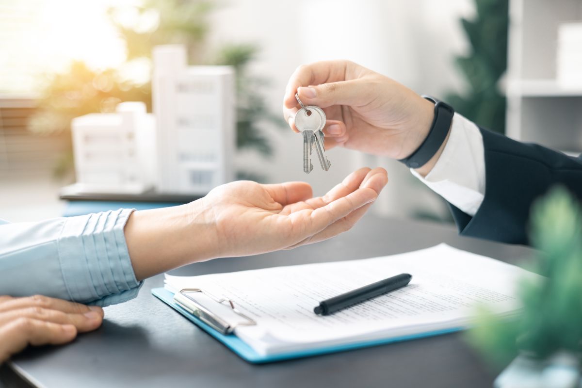 A homeowner receives the keys to their new home at the end of closing.