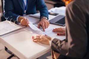 A buyer completes paperwork on closing day. 