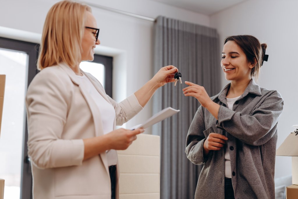 A buyer receives the keys to her new home.