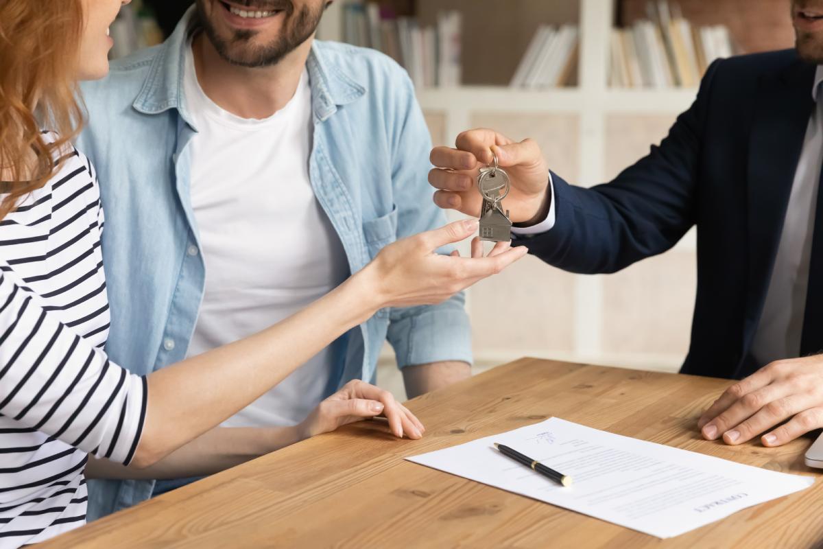 A couple getting the keys to their new house