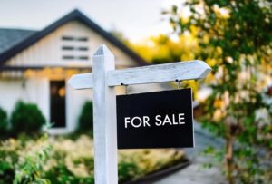 A house with a for sale sign 