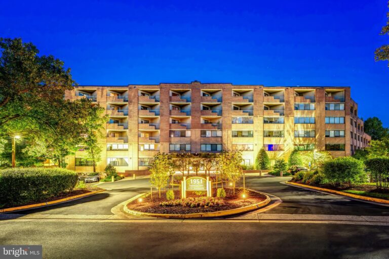 Mid-rise condominium building at dusk, 1951 Sagewood Lane 403, Reston, VA
