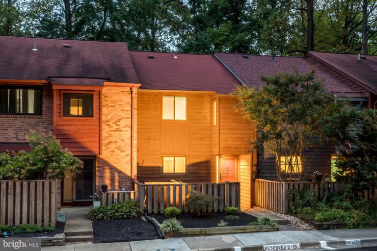 Brick townhome with wooden fence at dusk, 1914 Winterport Cluster, Reston, VA