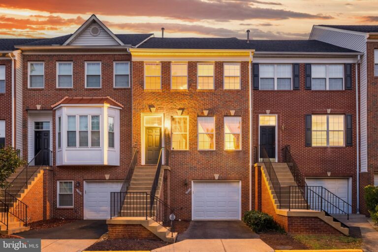 Brick townhomes with garages at dusk, 13323 Zachary Taylor Circle, Herndon, VA