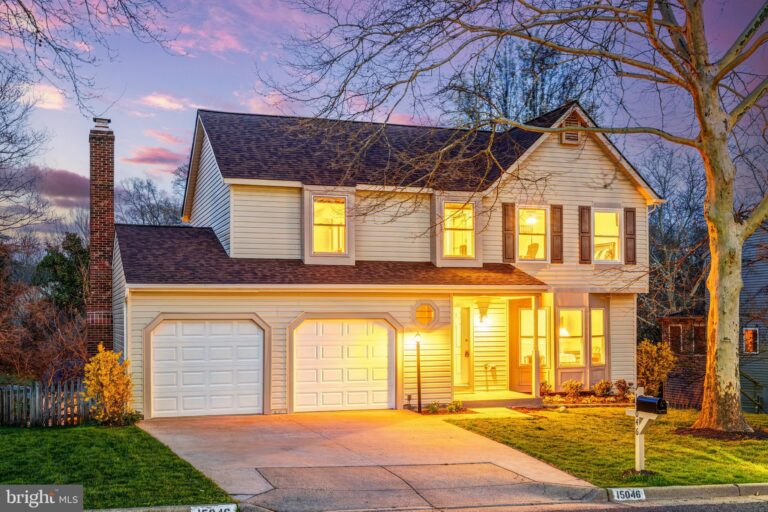Two-story home with two-car garage at dusk, 15046 Camellia Lane, Dumfries, VA