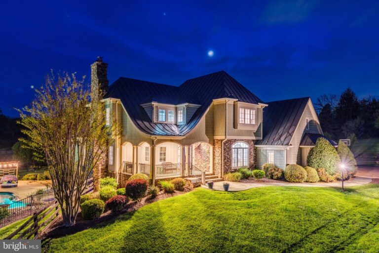Two-story home with landscaped yard at night, 18969 Peale Lane, Leesburg, VA