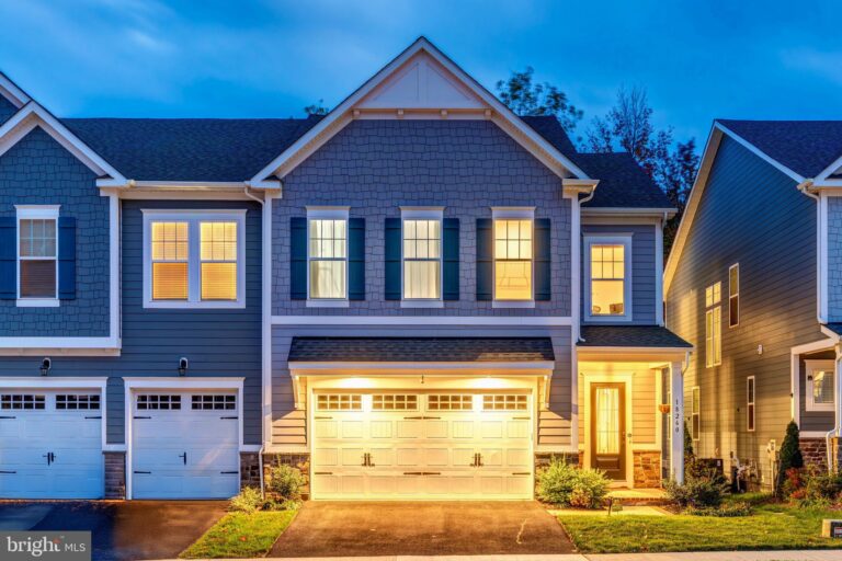 Two-story home with three-car garage at dusk, 18260 Moss Garden Road, Dumfries, VA
