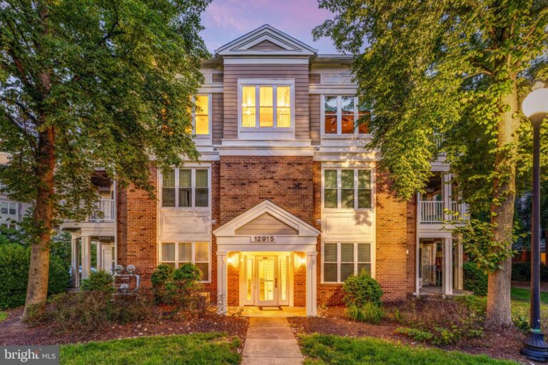 Brick townhome with lit entry at dusk, 12915 Alton Square 306, Herndon, VA