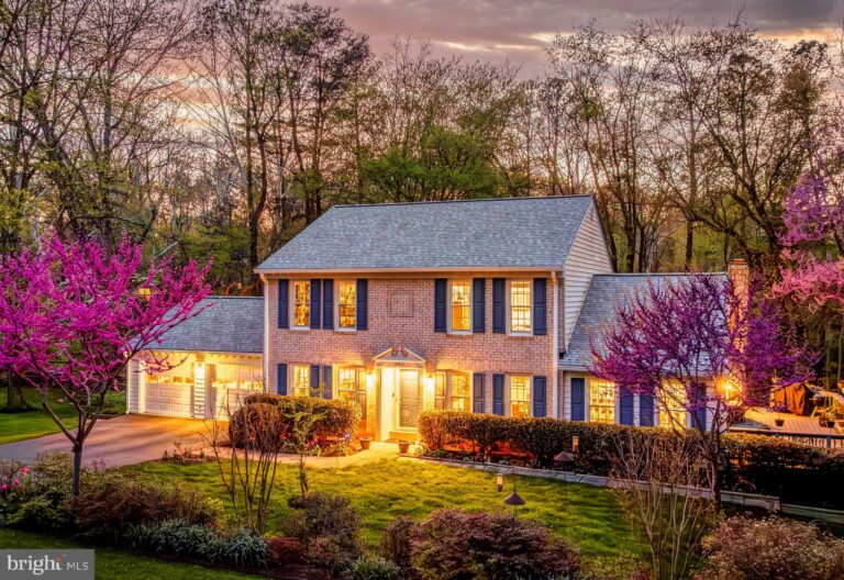 Colonial home with flowering trees at dusk, 10812 Hunt Club Road, Reston, VA
