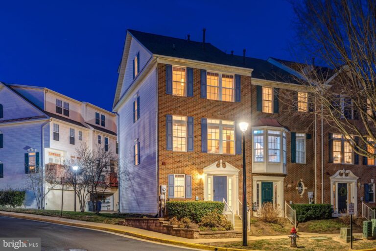 Three-story townhome with lit windows at night, 2772 Manhattan Place, Vienna, VA