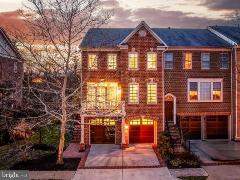 Brick townhome with garage at dusk, 113 Herndon Mill Circle, Herndon, VA