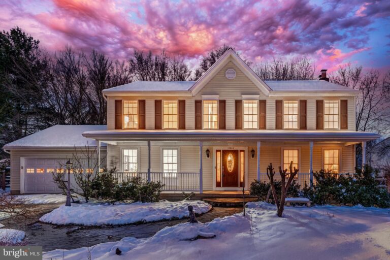 Colonial home with front porch in snow, 12604 Noble Victory Lane, Reston, VA