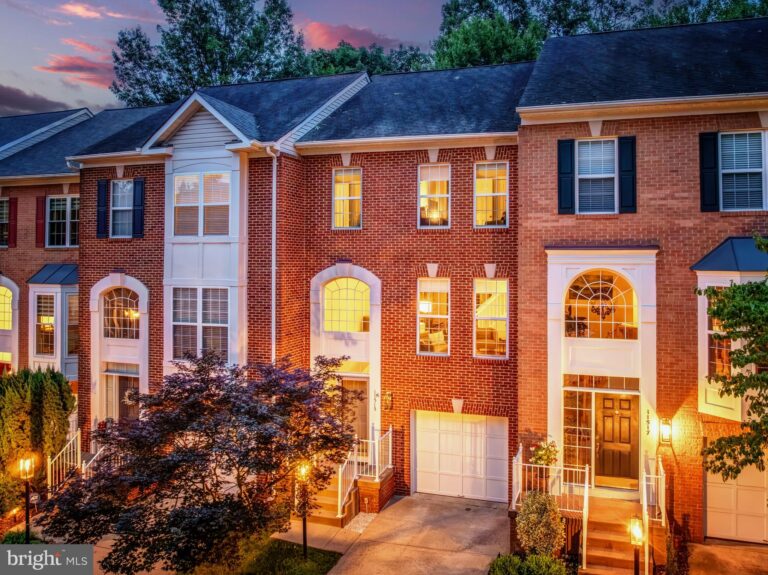 Brick townhomes with arched windows at dusk, 11515 Wild Hawthorn Court, Reston, VA