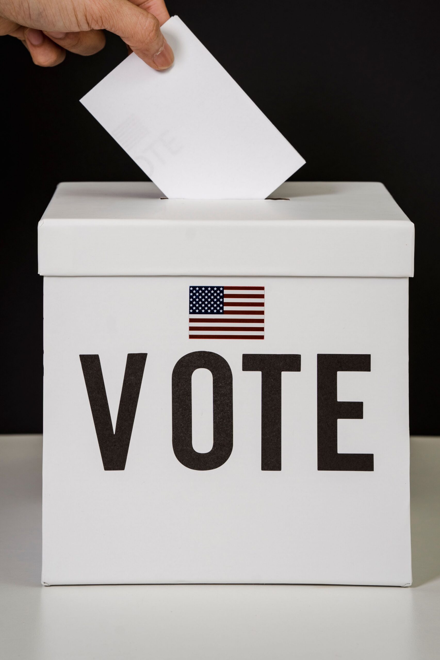 White ballot box with American flag and VOTE text