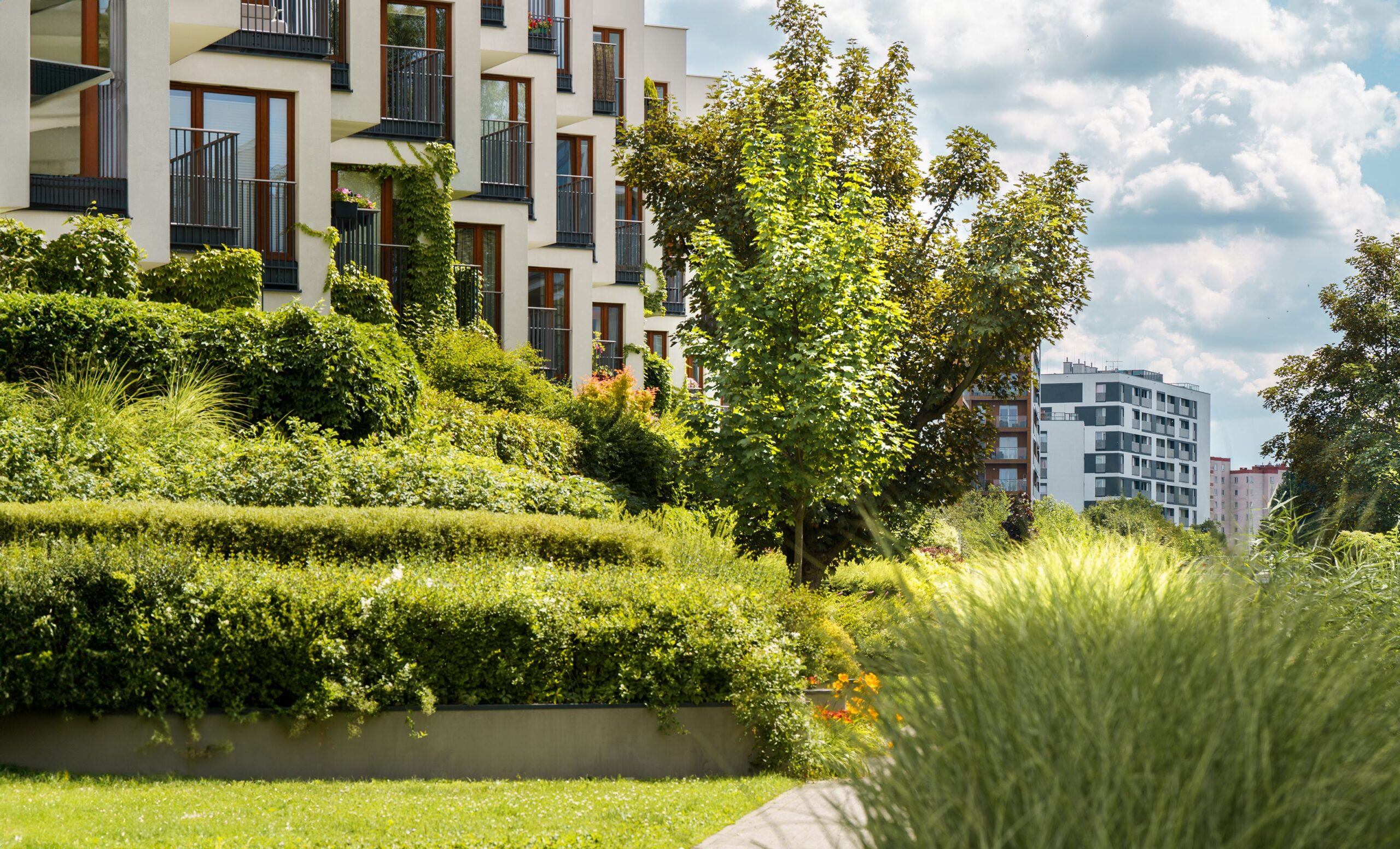 Modern mixed-use residential development with green park space, similar to the planned Reston Town Center North redevelopment