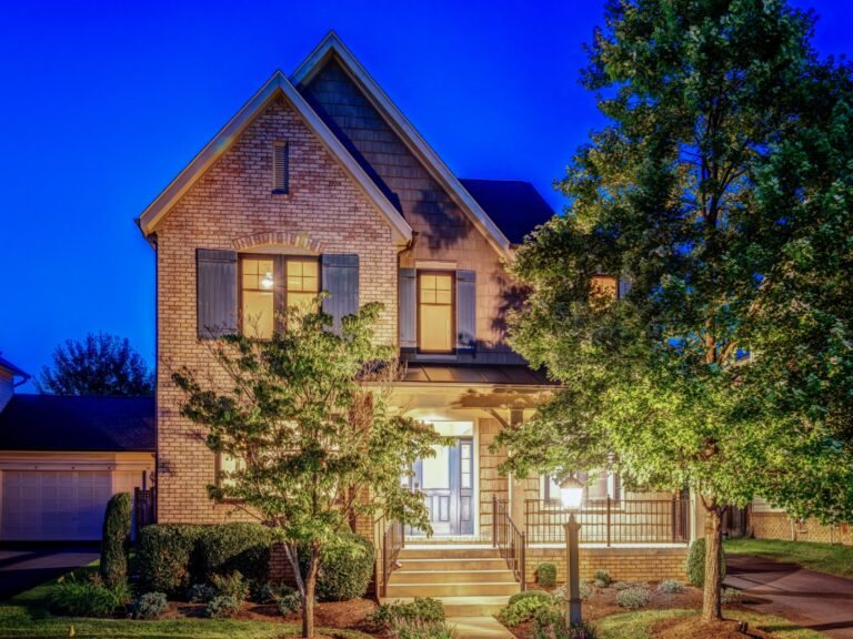 Brick-front home at twilight in Brambleton, Virginia