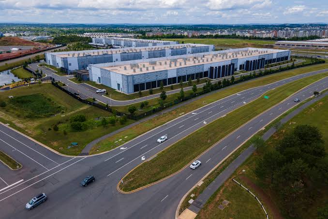 Aerial view of a large data center campus beside a highway in Northern Virginia