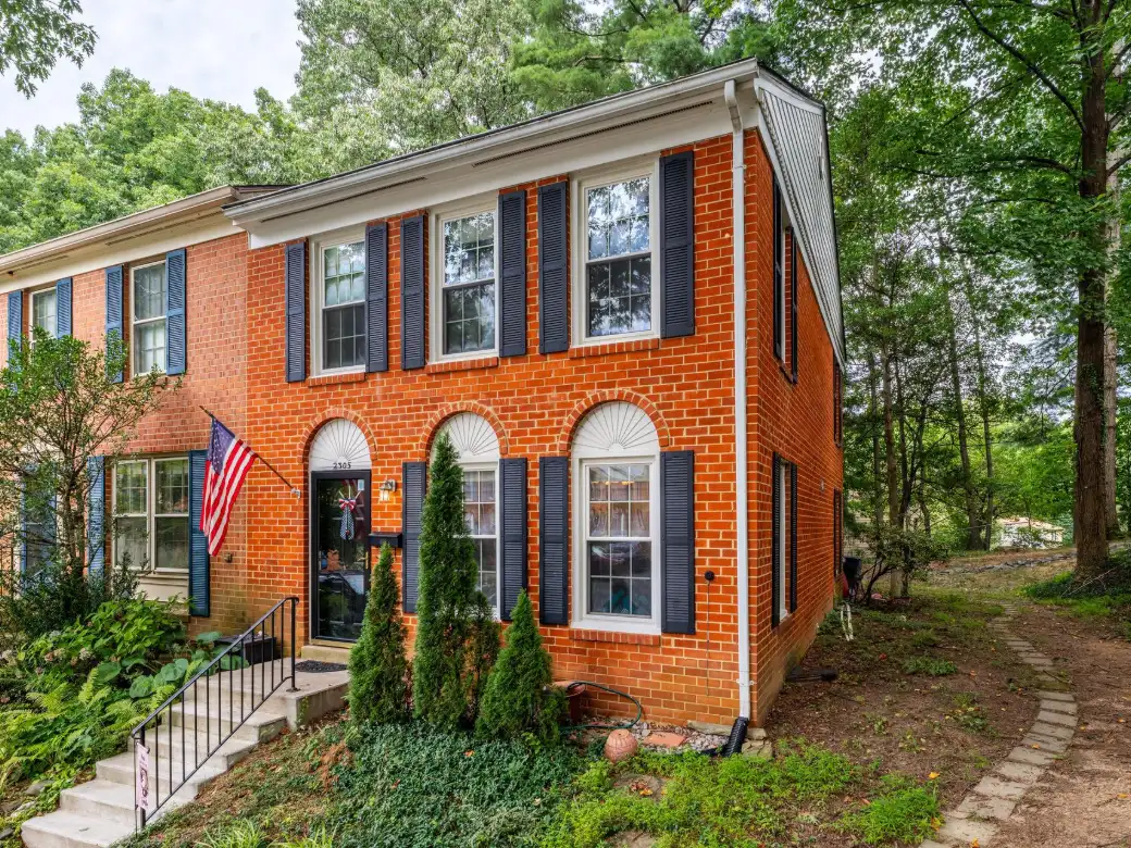 Brick colonial home with a landscaped front walk in Fairfax County, Virginia
