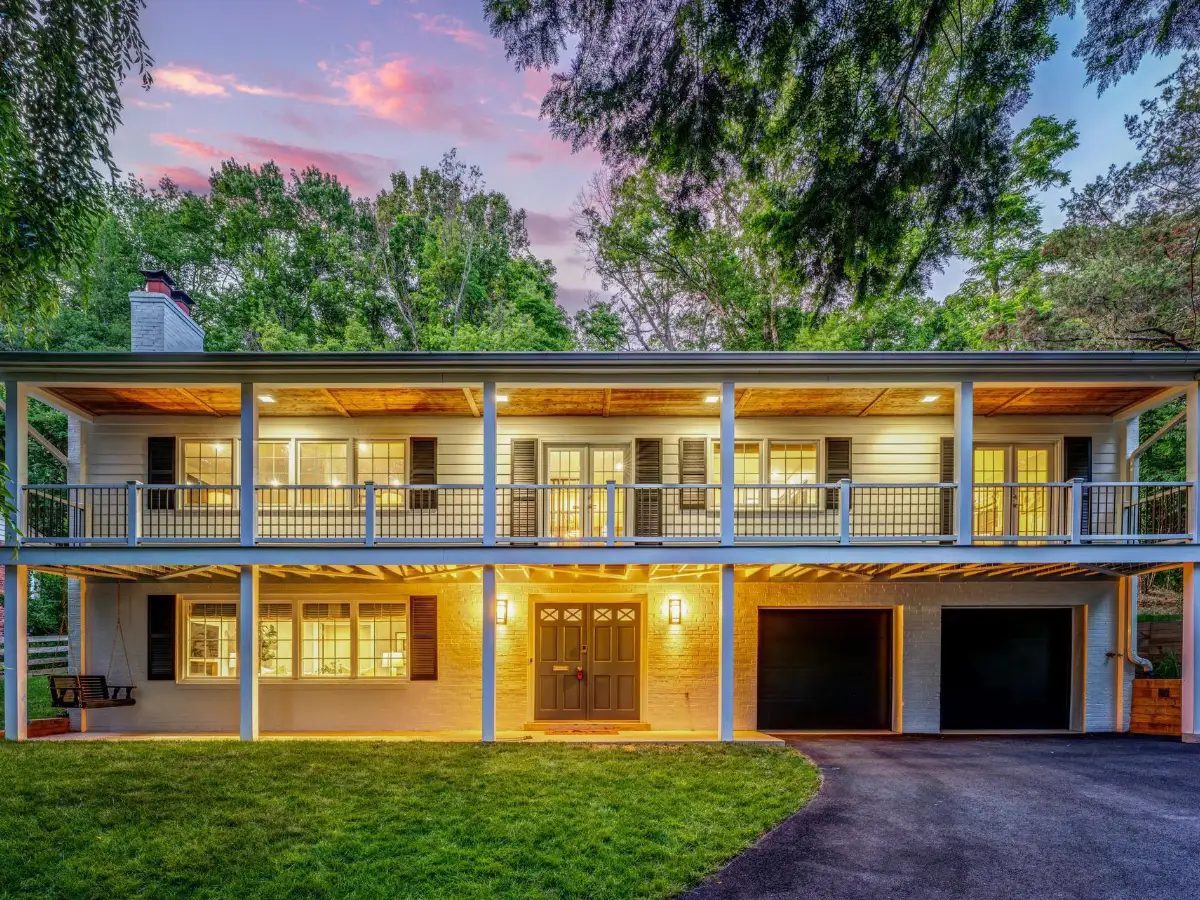 Two-story home with a covered balcony and front lawn in the Falls Church area of Fairfax County, Virginia