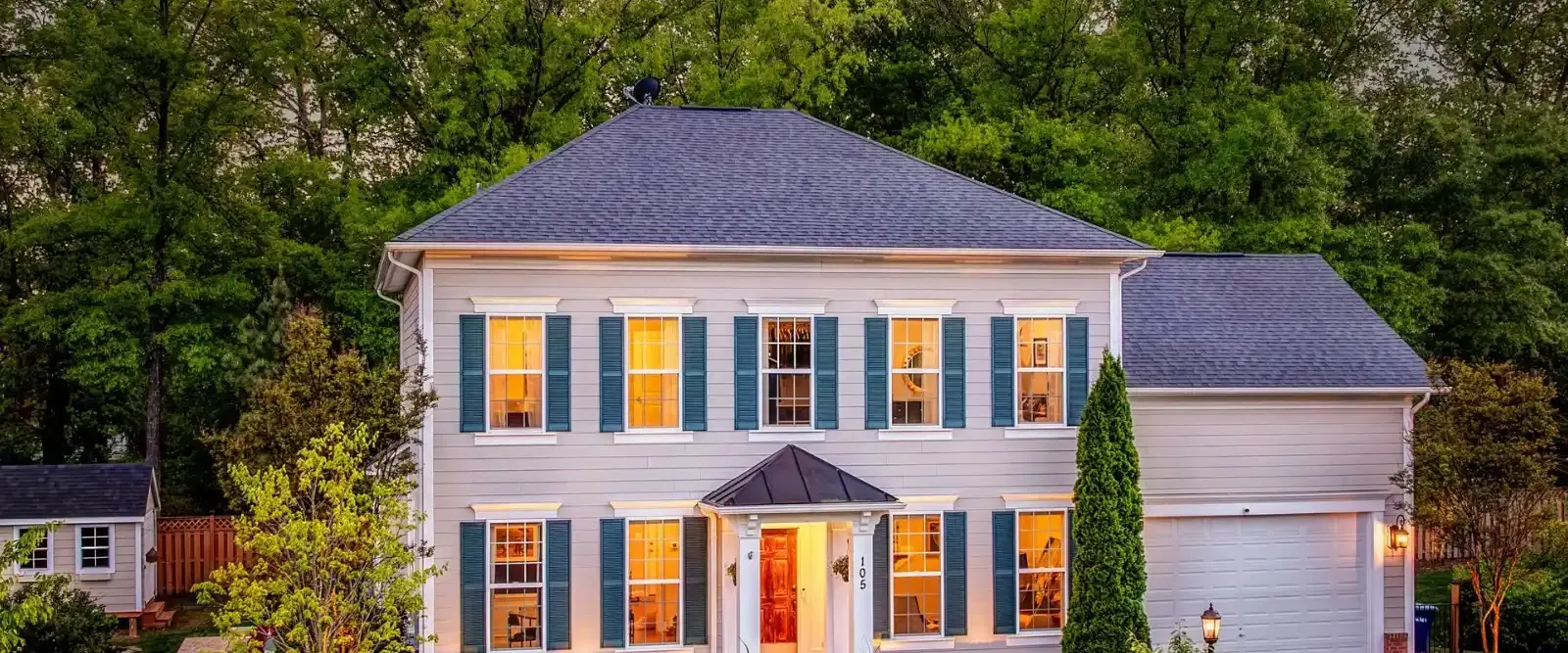 White colonial home with a front lawn in Fairfax County, Virginia