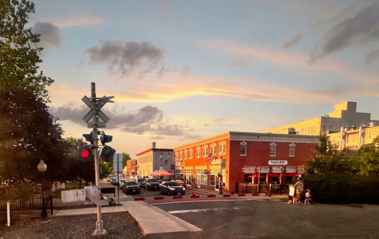 Historic Downtown Manassas, Virginia, at the railroad crossing near the depot at sunset