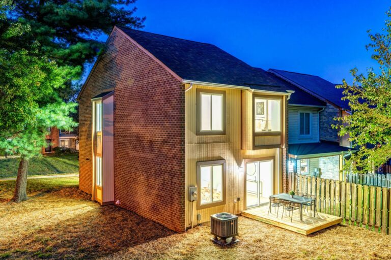 Back of a Lake Ridge townhome with a patio and mature trees, Woodbridge VA