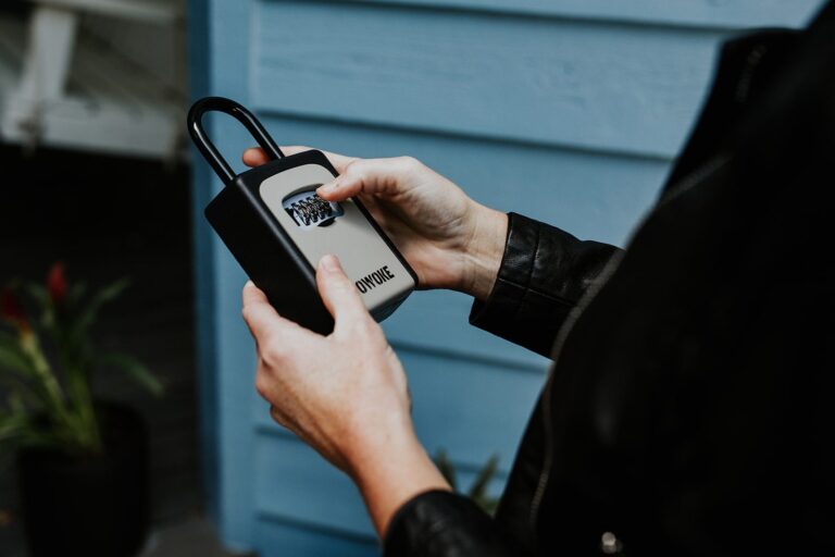 Close-up of Nikki Lagouros entering the code on a lockbox at a Northern Virginia home