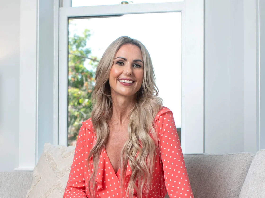 Nikki Lagouros, Northern Virginia realtor, smiling in a bright living room