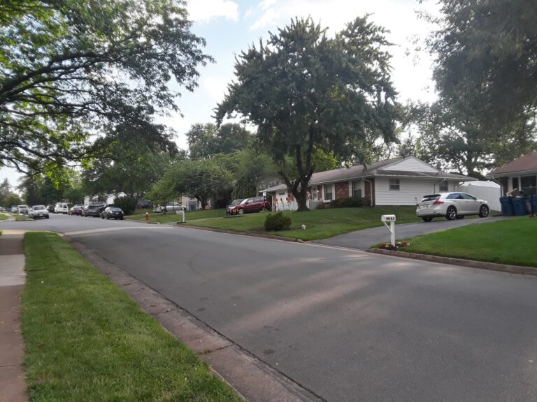 A tree-lined residential street of one-story houses in Sterling Park, Sterling, Virginia