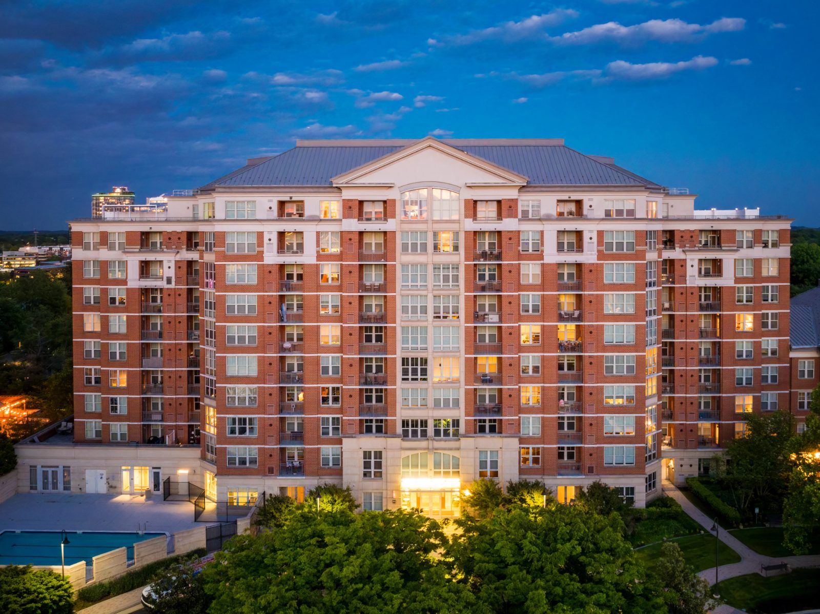 The Mercer condominium building near Reston Town Center in Reston VA at dusk, with its outdoor pool